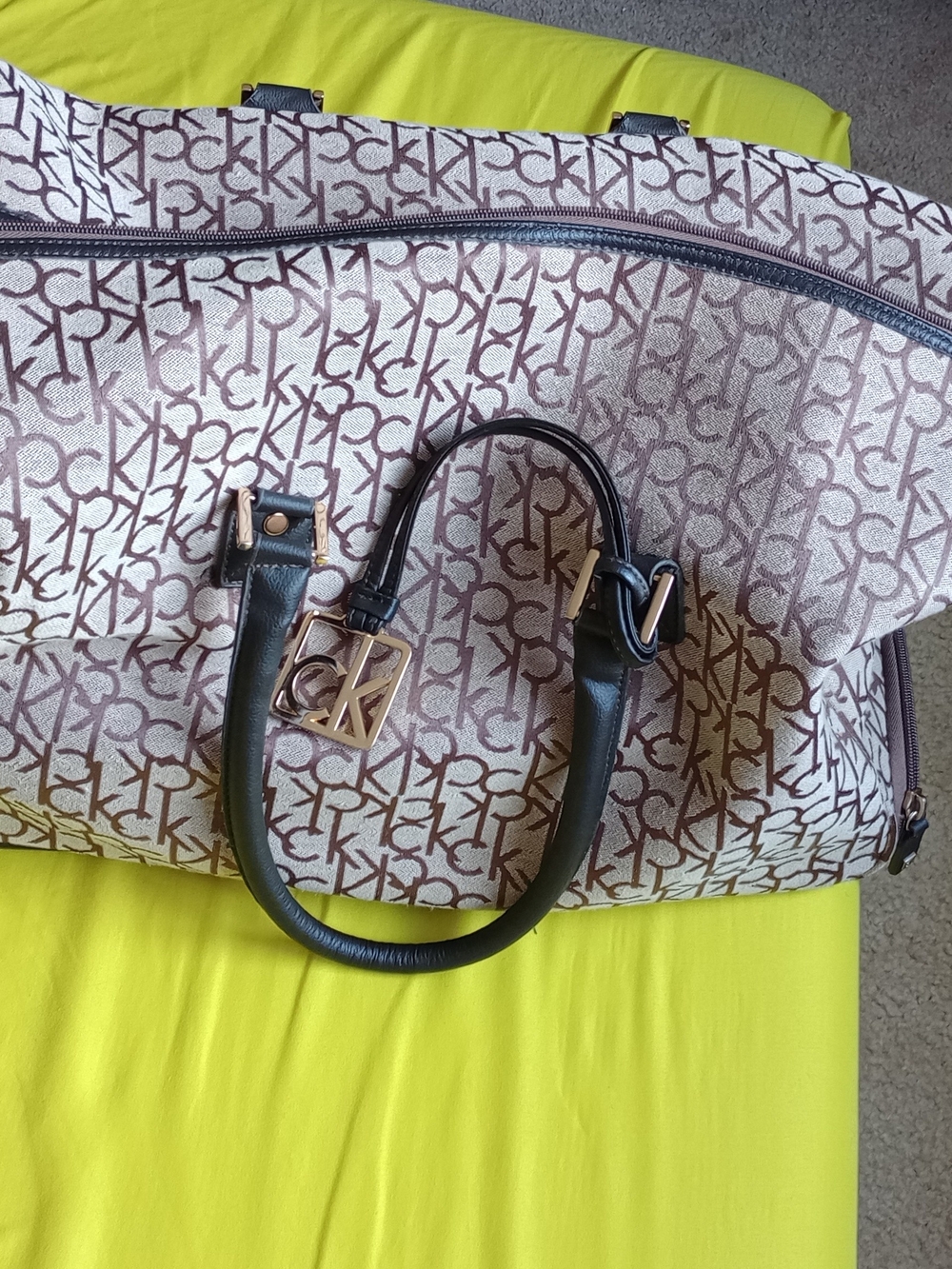 Calvin Klein Travel Weekender Duffle Bag featuring an all-over beige logo patter